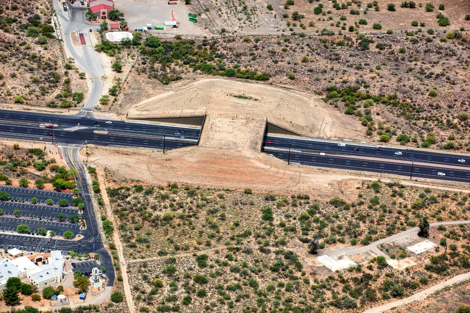 Aerial view of a highway interchange with graded earthwork alongside the roadway in Phoenix, AZ